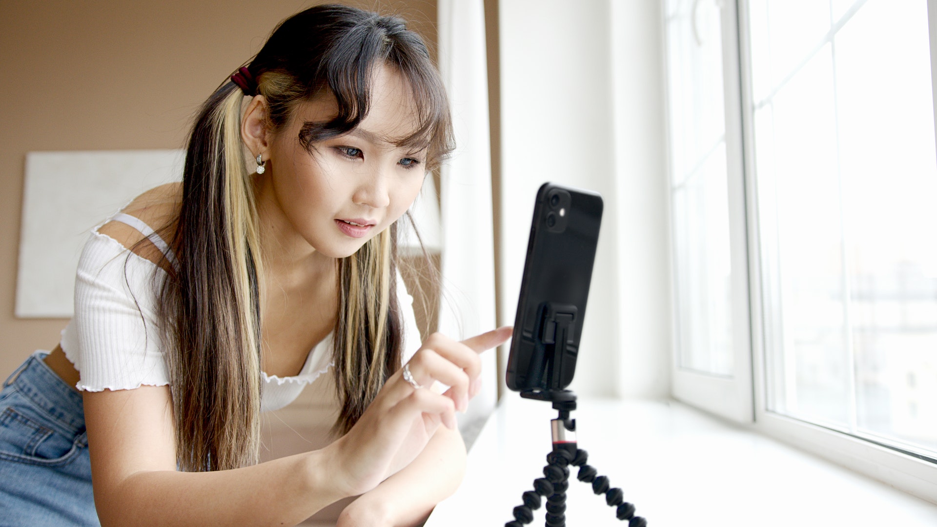 Girl using phone on tripod