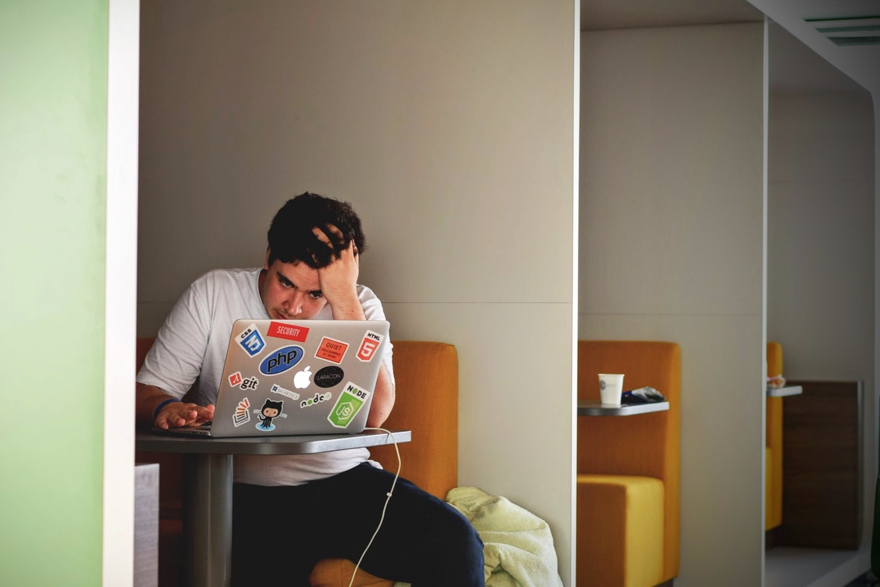 Stressed man using laptop